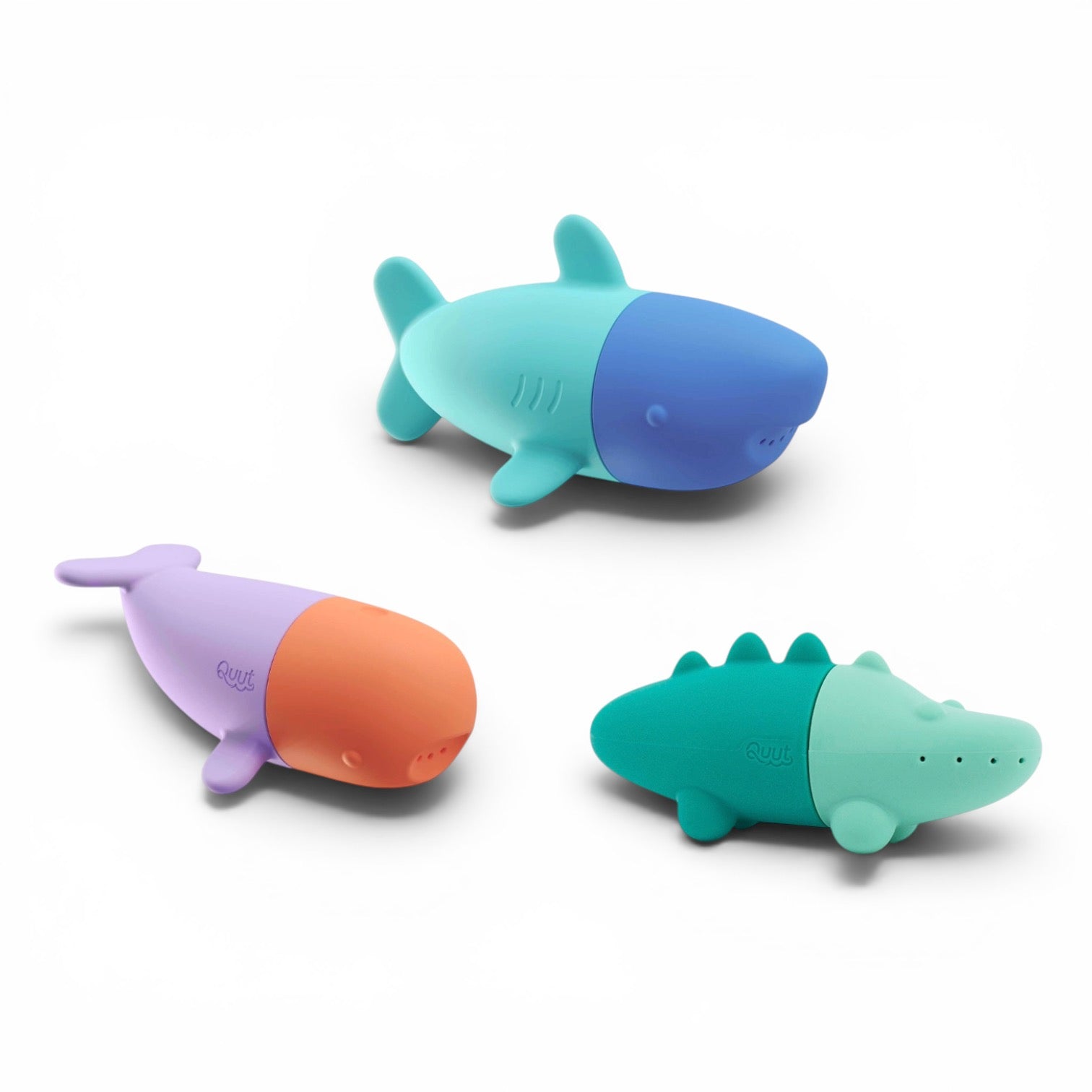 Three colorful bath toys shaped like a shark, whale, and alligator on a white background