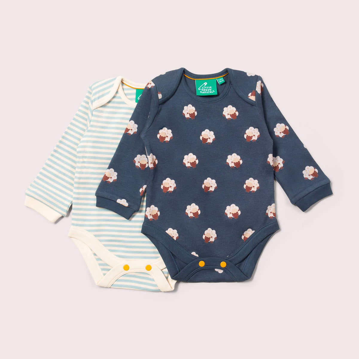 Two baby rompers on a light gray background
